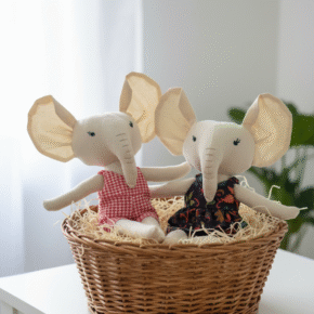 Handmade fabric elephant dolls sitting together in a basket